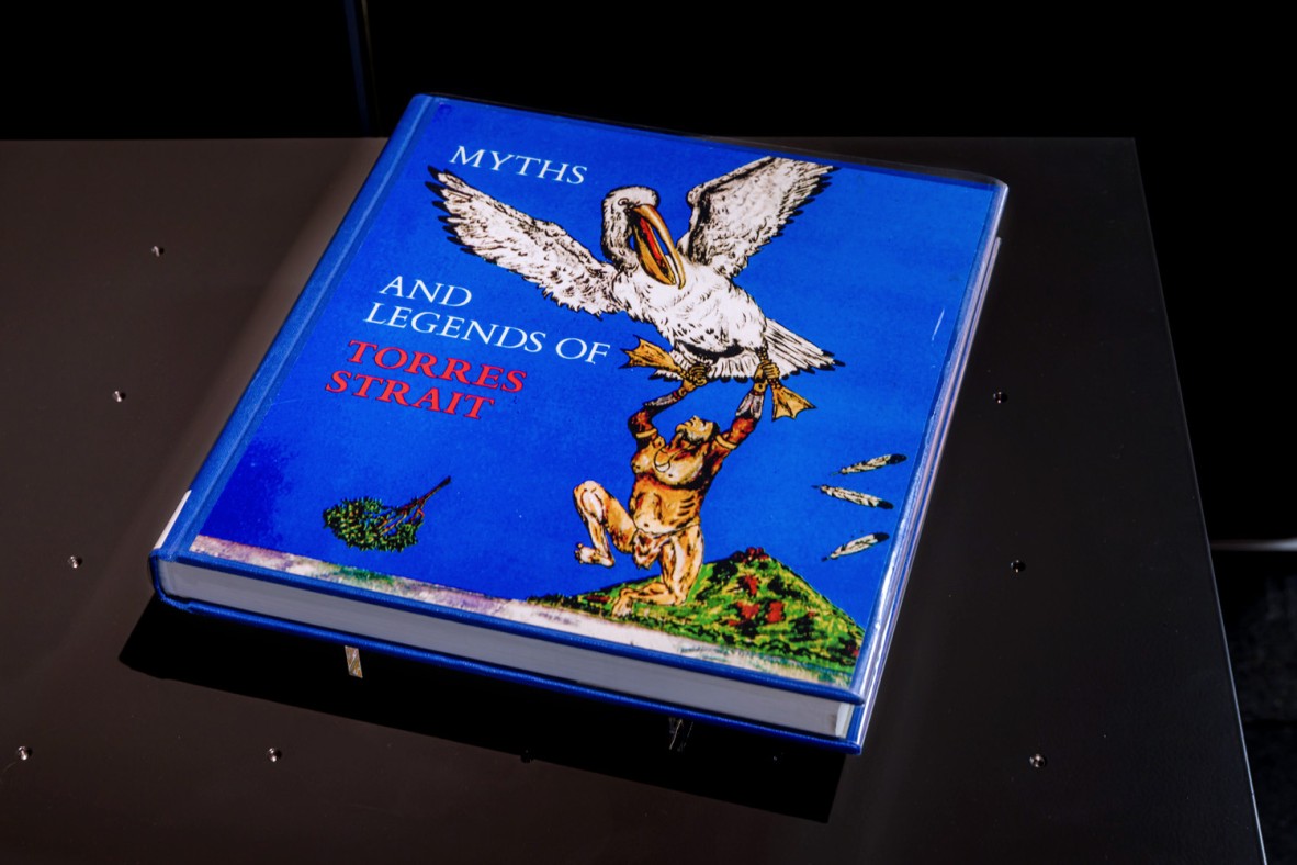 Book entitled 'Myths and Legends of Torres Strait' displayed in a glass cabinet.